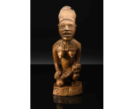 Maternity, wooden sculpture representing a female figure holding a child, Congolese - Yombe, 19th/20th C., minor defects. Not