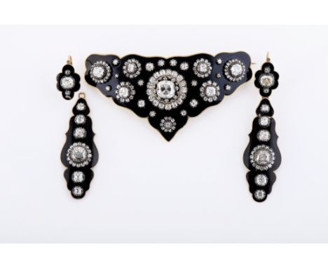 A demi-parure - brooch and pair of earrings, gold decorated with black enamel, brooch set with 148 antique cut diamonds with 