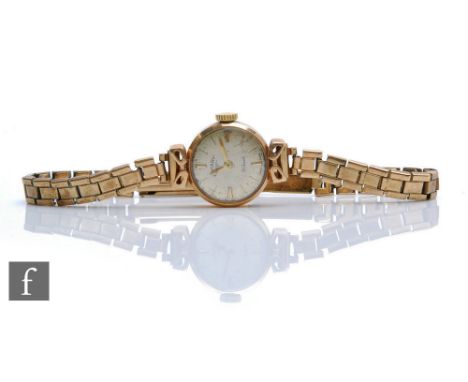 A 9ct lady's Rotary manual wristwatch with batons to a silvered circular dial, case diameter 16mm, all to a 9ct bracelet, tot