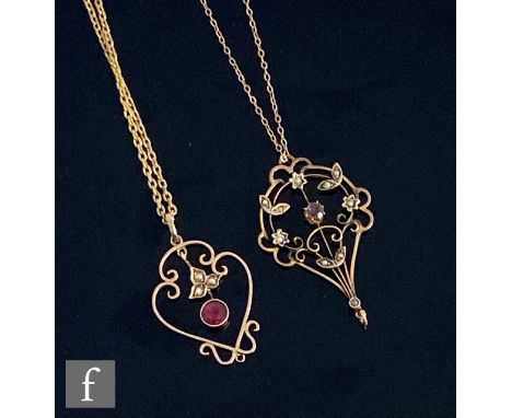 Two early 20th Century open work garnet and seed pearl set pendants, each missing stone drop, and suspended from gilt metal c