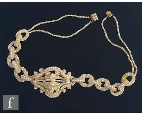 A cased 19th Century seed and mother of pearl choker comprising a central pierced cluster flanked by eight cluster of pearl l