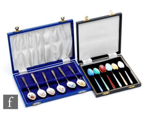 Two cased sets of six hallmarked silver teaspoons, one set with enamelled floral decoration to bowls, the other with a differ