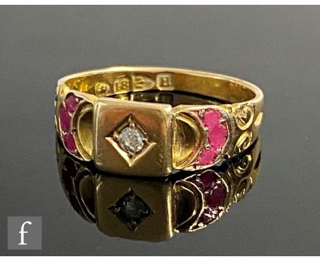An 18ct hallmarked ruby and diamond ring, central diamond flanked by three rubies to each shoulder, weight 3.3g, ring size M,