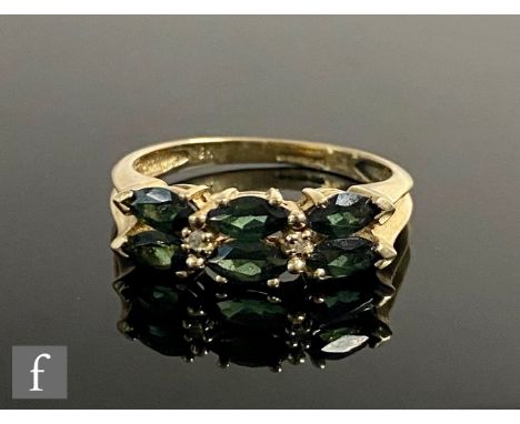 A 9ct hallmarked green garnet and diamond ring, three pairs of oval garnets spaced by a single diamond, all to&nbsp;chamfered
