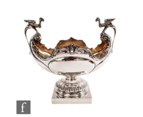 An early 20th Century hallmarked silver table centre piece, square base supporting boat shaped bowl of plain form detailed wi