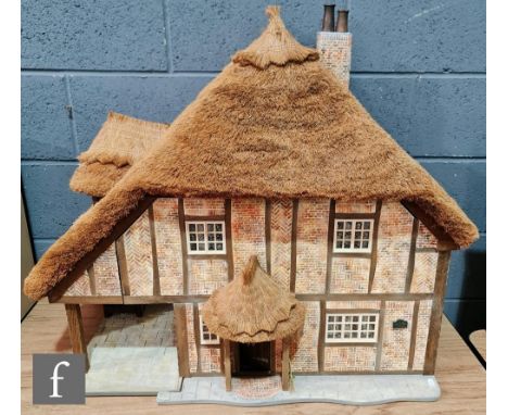 A Little Homes of England 1:12 scale dolls house modelled as a thatched cottage by Graham Wood, two storeys with four rooms, 