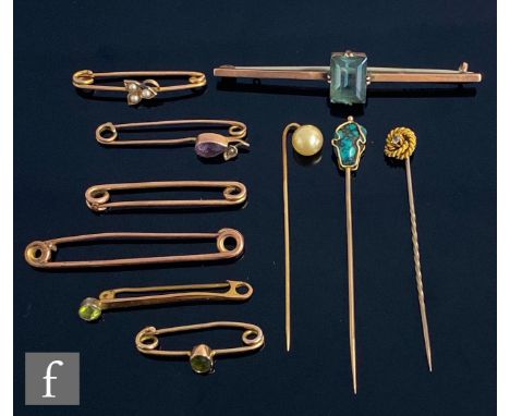 Seven assorted early 20th Century 9ct stone set and plain bar brooches with three similar stick pins, total weight 16.5g, S/D