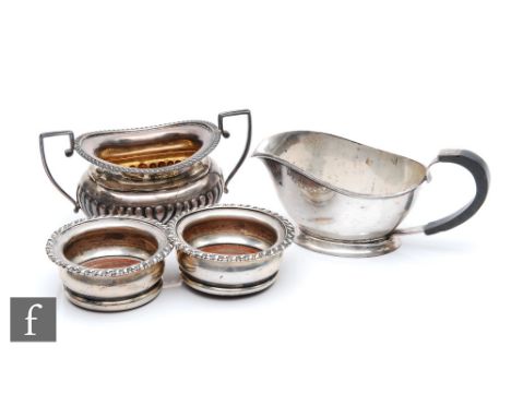 A pair of hallmarked silver bottle coasters each with a wooden base, diameter 9cm, Birmingham 1911, with a silver sugar basin