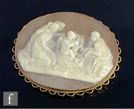 A modern 9ct mounted oval cameo brooch depicting three seated woman and a cherub playing a lyre, weight 16g, length 58mm, hal