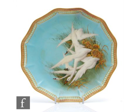 A Royal Worcester cabinet plate decorated by Charlie Baldwin with four hand painted swans in flight against gilt grasses to a