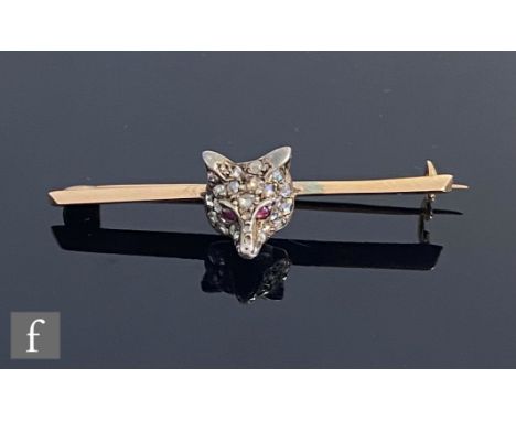 An early 20th Century ruby and diamond set fox's head bar brooch, cabochon ruby eyes to a diamond set head, weight 3.9g, leng