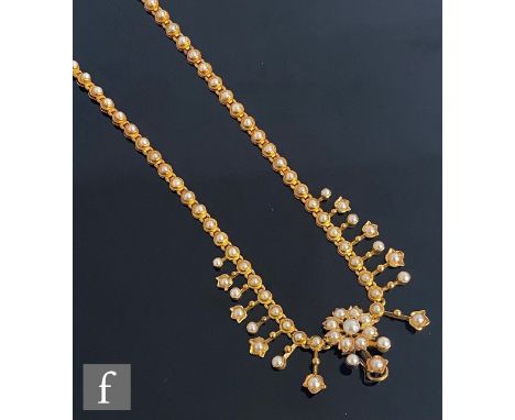 An early 20th Century cased seed pearl necklet with central split pearl cluster flanked by eight stiff drops with single ston