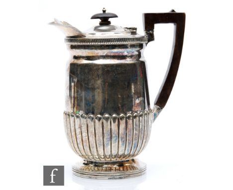 A hallmarked silver hot water pot with part fluted decoration terminating in angular wooden handle, weight 20.5oz, height 19c