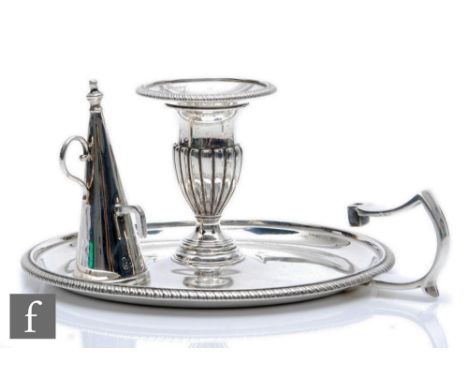 A Georgian hallmarked silver chamber stick and associated snuffer, beaded border and engraved crests to stick, total weight 1