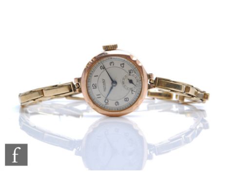 A hallmarked 9ct rose gold lady's Rotary wristwatch, Arabic numerals to a silvered dial and 9ct spring loaded bracelet, total