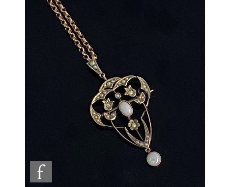 An early 20th Century 9ct open work pendant set with two opals to a seed pearl border, length 5cm, suspended from a 9ct belch