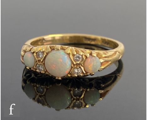 An 18ct opal and diamond seven stone boat shaped ring, three opals spaced by two pairs of diamonds, weight 5.2g, ring size S.