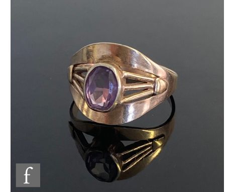 A 9ct single stone amethyst ring, oval collar set stones to strut shoulders and a wide head, weight 2.8g, ring size Q. 