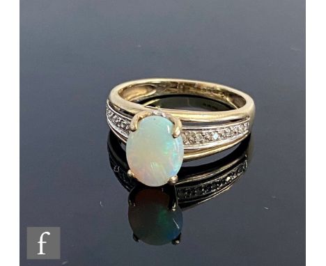 A 9ct hallmarked opal and diamond set ring, high set opal to diamond set shoulders, weight 2.8g, ring size N. 