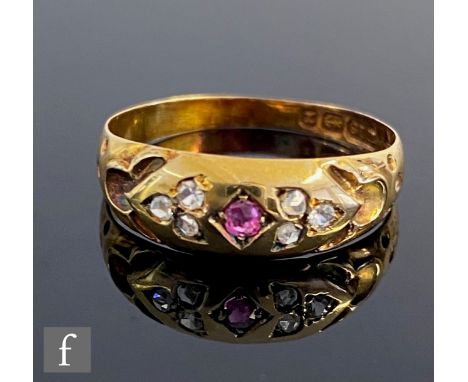 An 18ct hallmarked ruby and diamond seven stone, gypsy set boat shaped ring, weight 1.7g, ring size N 1/2, Birmingham 1897.