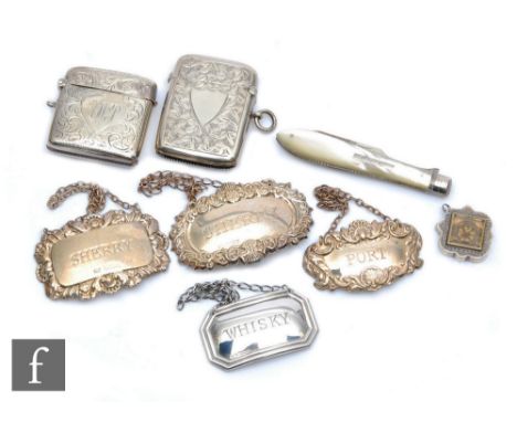 A small parcel lot of hallmarked silver items four assorted decanter labels, two vesta cases, a compass fob, various dates an