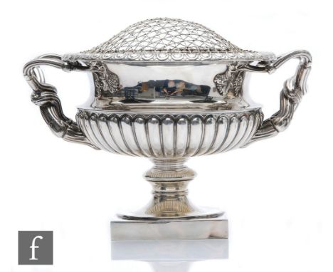 A hallmarked silver pedestal bowl modelled in the manner of The Warwick Vase, square base rising to part fluted circular bowl