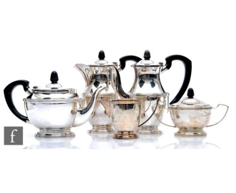 A hallmarked silver five piece pedestal tea set of plain form with reeded details, the three pots and sugar basin all with ac