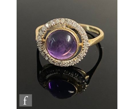 A 9ct hallmarked amethyst and diamond halo ring, central cabochon collar set amethyst within a border of diamonds, weight 2.3