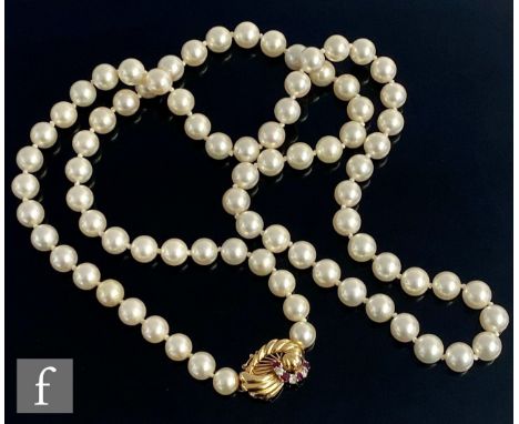 A single row of uniform cultured pearls each approximately 7mm in diameter, terminating in an 18ct ruby and diamond tongue an