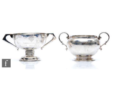 A hallmarked silver twin handed sugar basin with a similar small trophy cup, total weight 10.5oz, various dates and makers. (