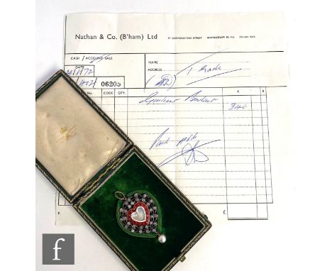 A late 19th Century 14ct pendant, central glass heart shaped panel within a red and white enamelled border with gilt highligh