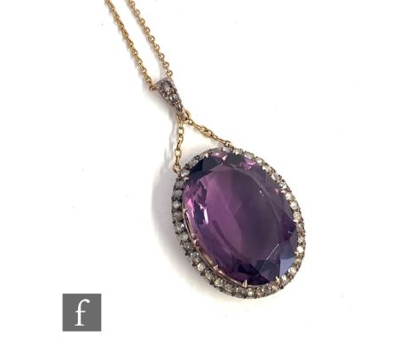 A late 19th Century 9ct amethyst and diamond pendant, central oval facet cut claw set amethyst length approximately 28mm, wit