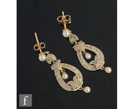 A pair of early 20th Century 18ct diamond drop earrings, pave set tapering oval drops each detailed with three seed pearl hig