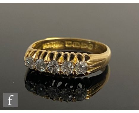 An 18ct hallmarked diamond five stone, boat shaped ring, claw set old cut stones to plain shoulders, weight 5.2g, ring size R