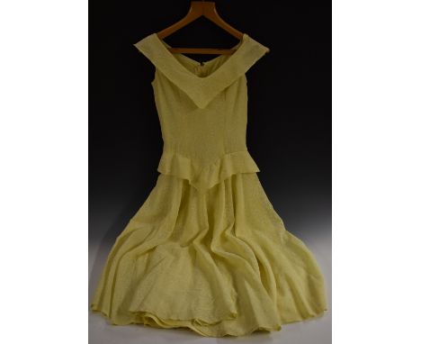 A 1950s day dress, white printed srig pattern on lemon yellow ground, sleeveless fitted bodice, full skirt, approximately 570