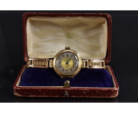 Buren - a lady's 9ct gold wristwatch, silvered gilt dial, Arabic numerals, manual movement, ornate expanding bracelet strap, 