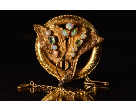 A Victorian opal and green tourmaline brooch, free form stone set panels, wrap around floral and rope twist frame, 15ct gold 