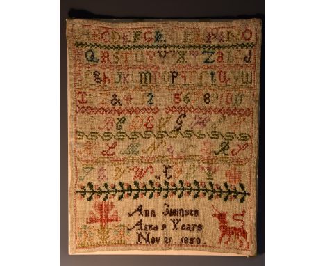 A Victorian sampler, Ann Swinsco, aged 9 years, Nov 21 1850, depicting flora and a dragon, alphabet