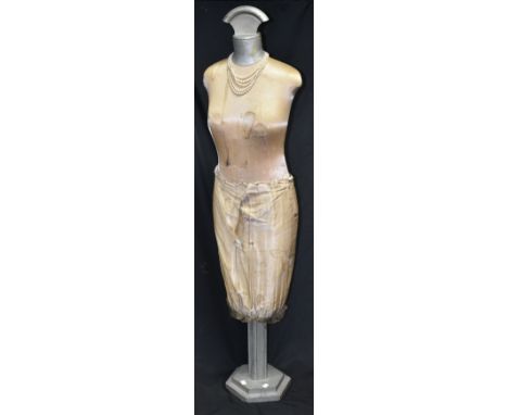 An Art Deco female mannequin, fan shaped finial, hexagonal base