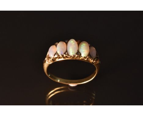 A Victorian opal and diamond ring, five graduated oval opal cabochons each with red, orange, green and blue colour play, each