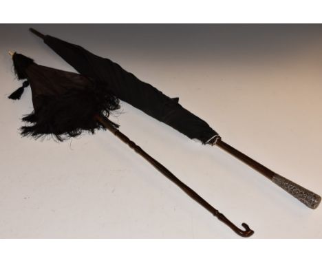 A mid-Victorian lady's black silk folding sun parasol, lacquered mahogany sectional stick terminating in a crook shaped handl