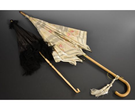 A Victorian black silk parasol, carved bone finial, fringed edge; another, Edwardian, cream silk (2) 