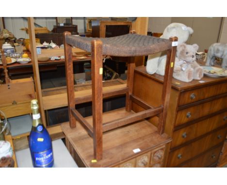 An oak and string topped stool