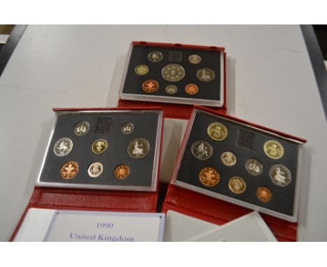 Three cased proof coin sets