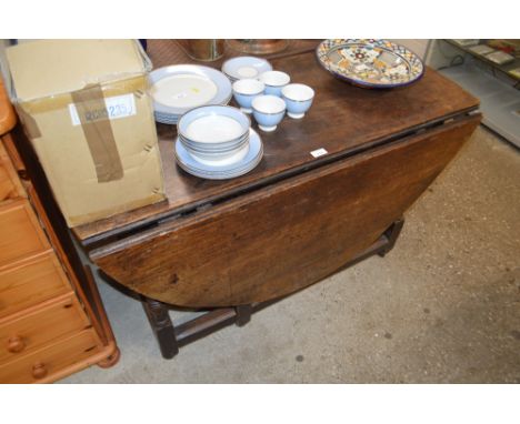 An antique oak gate leg dining table 