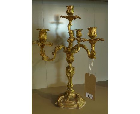 An ormolu Rococo style three branch four light candelabra, with C-scroll decoration, H.48cm