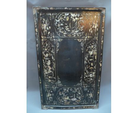 A Chinese black lacquered mother of pearl inlaid tray, decorated with vignettes of figures and animals in woodland scenes, L.