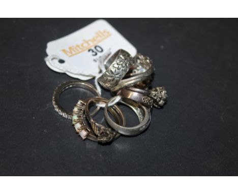 A silver and cubic zirconia half hoop eternity ring, set with eleven brilliant cut circular stones, ring size T and eight oth