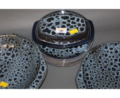 A Poole mottled blue glazed pottery part dinner service, comprising two-handled bowl, two-handled plate, lidded oval butter d