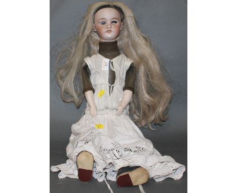 A 19th century Halbig bisque porcelain headed doll, with blue eyes, the leather body with porcelain hands and composition fee